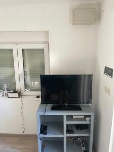 a television sitting on a table with a tv at House Lovre in Zadar