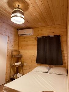a bedroom with a bed in a wooden wall at Boutique Thomas בוטיק תומאס in Haifa