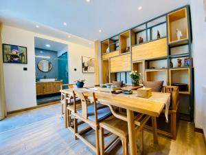 a dining room with a wooden table and chairs at Xi'an Simple Palace in Xi'an