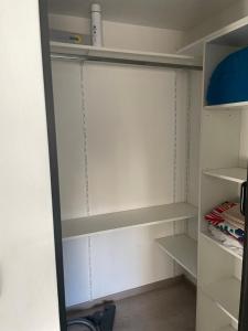 a closet with white walls and white shelves at House Lovre in Zadar +4 photos