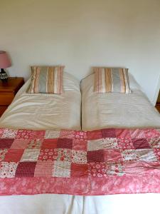 a bed with two pillows on top of it at Egen ovanvåning i charmig villa nära havet in Ystad