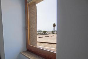 an open door with a view of a parking lot at Casa nel Blu in Portoscuso