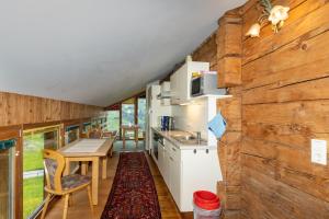 a kitchen and dining area of a tiny house at Haus Holzwurm in Raggal