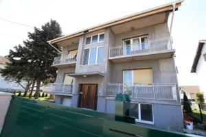 a house with a fence in front of it at Apartment Vujovic in Kladovo