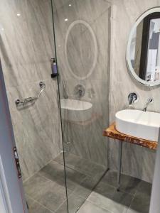 a bathroom with a shower and a sink at Hotel Almira in Agia Triada