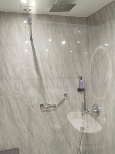 a bathroom with a shower with a sink in it at Hotel Almira in Agia Triada
