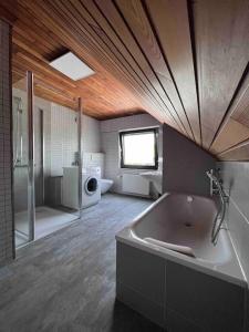 a large bathroom with a tub and a shower at Gasthaus Maarfeld Gerolstein in Gerolstein