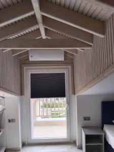 a room with a large window and a large door at Hotel Almira in Agia Triada