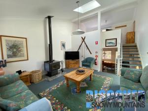 a living room with a couch and a table at Three Bears 2 in Thredbo