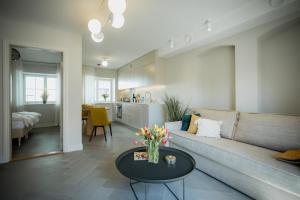 a living room with a couch and a table at Güldenstubbe Residences in Kuressaare +37 photos