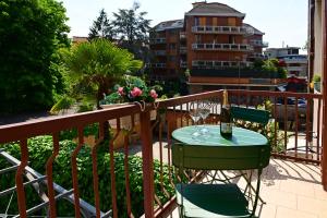 una mesa con una copa de vino en el balcón en Holiday Homes Aparthotel Milano, en Milán