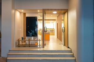 a hallway with stairs leading into a building at Aank Hotel Daejeon Yongjeon 2 in Daejeon