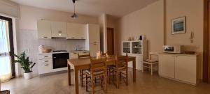 a kitchen with a table and chairs in a kitchen at Nonna Eleonora in Otranto +4 photos