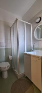 a bathroom with a toilet and a shower and a sink at Nonna Eleonora in Otranto