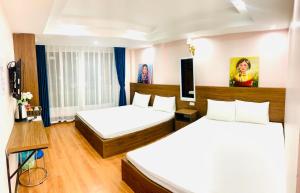 Giường trong phòng chung tại My Dream Hotel