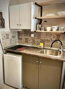 a kitchen with a sink and a counter top at Grecian Sea in Limenaria