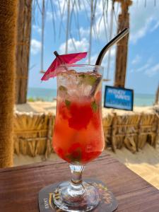 a drink in a glass sitting on top of a table at Windy Waves Kite Beach & Nature Resort in Kalpitiya