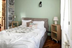 a bedroom with a large bed with white sheets at Il Moderno by Holiday Solutions in Como