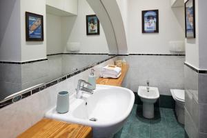 a bathroom with a sink and a toilet at Il Moderno by Holiday Solutions in Como +17 photos