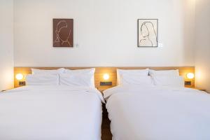 Rúm í herbergi á Aank Hotel Daejeon Yongjeon 2nd