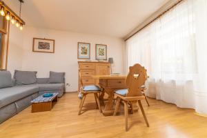 a living room with a table and a couch at Ladurner Home in Brunico
