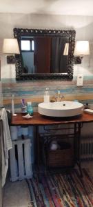 ein Bad mit einem Waschbecken und einem Spiegel in der Unterkunft Casa Calma en Sierra de Vicort, Zaragoza in Inogés