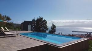 a swimming pool with a view of the water at Azores Haven Hill in Horta