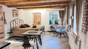 a bedroom with a bed and a table and chairs at Apartamenty 3 Pory Roku in Komarno
