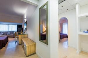 a living room with a couch and a mirror at Summit Hotel in Gaeta