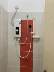 a shower in a bathroom with a red and white wall at SSR Stay n rest 887芙蓉休闲站民宿 in Seremban