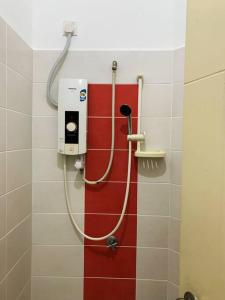 a shower in a bathroom with a red and white wall at SSR Stay n rest 887芙蓉休闲站民宿 in Seremban