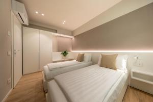 a bedroom with a large bed with white sheets at Residenza Betteloni in Bardolino