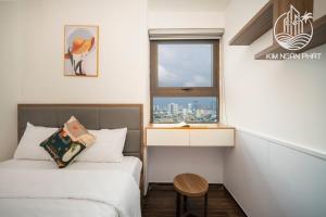 a small room with two beds and a window at Kim Ngan Phat Deluxe Apartment in Danang +263 photos