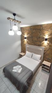 A bed or beds in a room at Alexander Apartments Nea Koutali