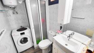 a bathroom with a washing machine and a sink at Sweet Flat with private patio Dunasol in Corralejo +11 photos