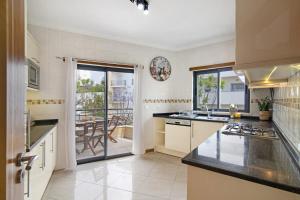 a kitchen with a sink and a counter top at Flat with Pool Marina and Sea View in Albufeira