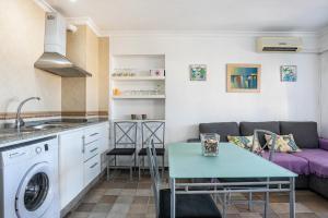 a kitchen and living room with a couch and a table at Casa Vistas al Mar Bolonia 2 in Tarifa