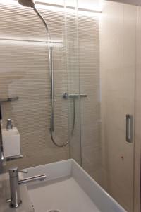 a bathroom with a shower with a tub and a sink at Casa Bartoccio - Casa vacanze in Fermignano