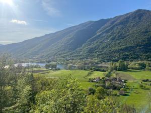 a view of a valley with a lake and mountains at ALTRAVISTA TARZO in Revine Lago