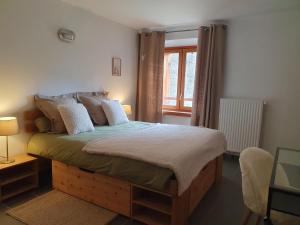 a bedroom with a large bed and a window at Refuge Hôtel de Bayasse in Uvernet-Fours