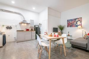 a kitchen and living room with a table and chairs at Super Mario Sea House by Pleiades Home in Livorno