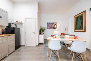 a kitchen and dining room with a table and chairs at Super Mario Sea House by Pleiades Home in Livorno +27 photos