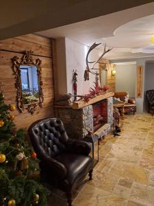 a living room with a christmas tree and a fireplace at Zwei Hirsche in Seefeld in Tirol