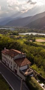 a building with a view of a river and mountains at ALTRAVISTA TARZO in Revine Lago +56 photos