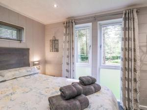 a bedroom with a bed with two towels on it at Ewe Crag Beck Lodge in Whitby