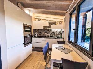 a kitchen and dining room with a table and chairs at I Particolari in Lerici +12 photos