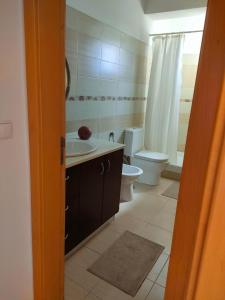 a bathroom with a toilet and a sink and a shower at A place to rest and enjoy in Piedade