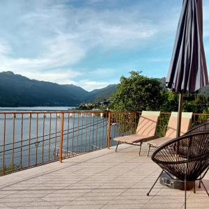 a patio with an umbrella and chairs on a balcony at Ancoradouro T1 - Alojamento Local Gerês in Braga