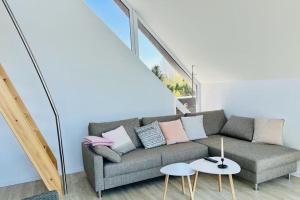 a living room with a couch and a table at Lichtdurchflutete Ferienwohnung mit direktem Schleiblick in Fahrdorf