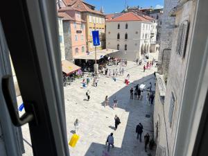 a group of people walking down a street at Split Old Town Apartments in Split